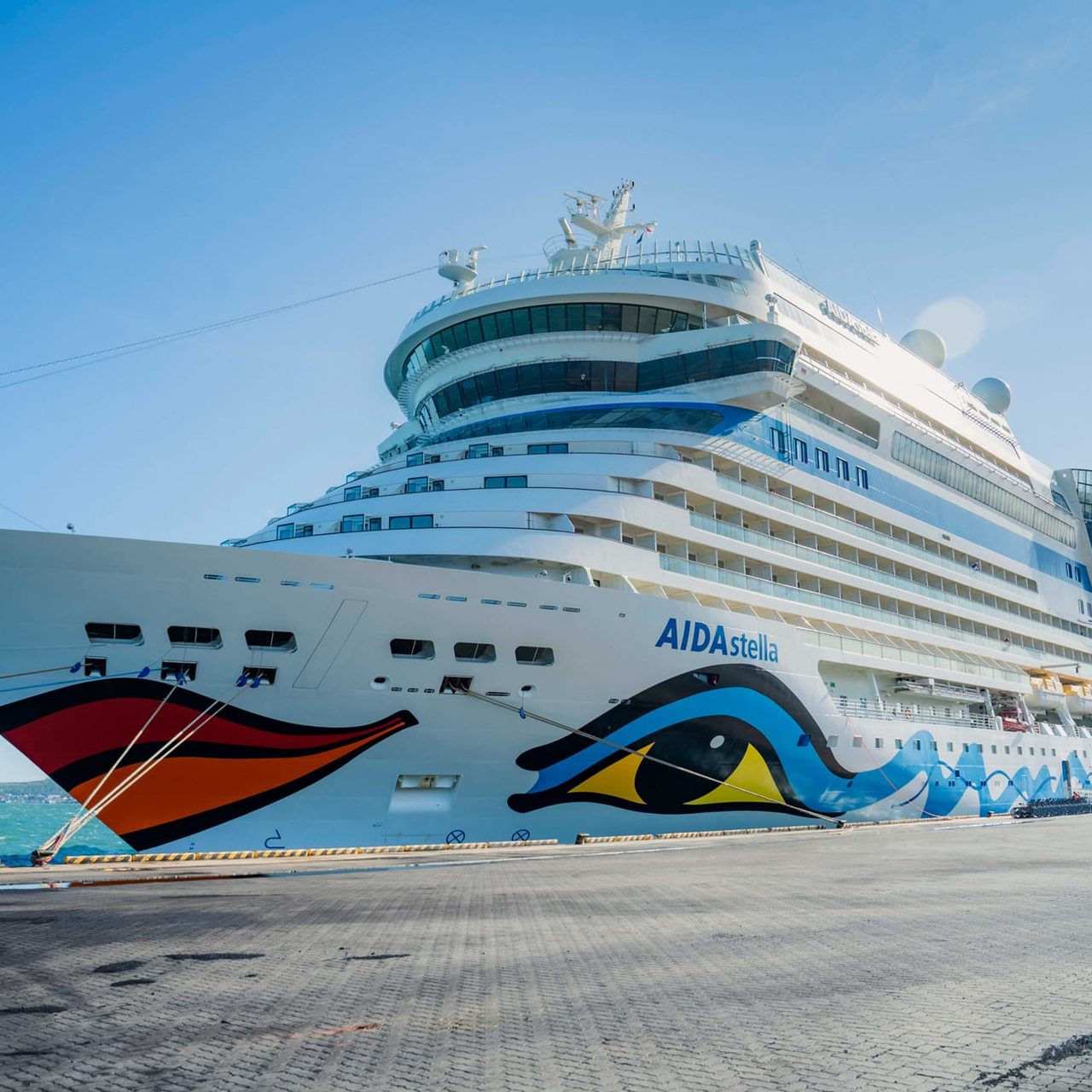 AIDA STELLA cruise ship with nationality of ITALY, length of 253.3 meters, width of 32.20 meters, and depth of 7.3 meters, docked safely at PAS